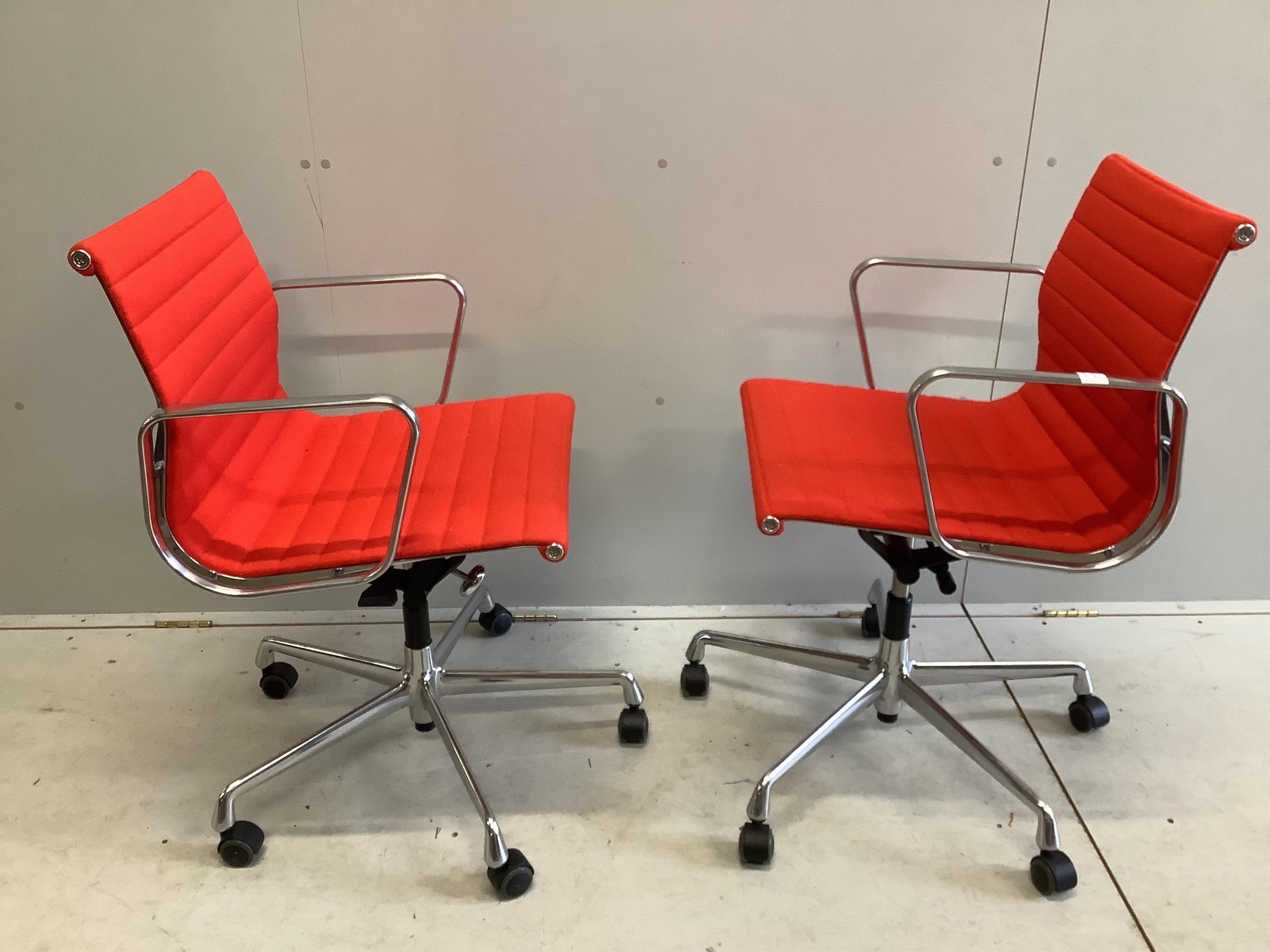 A pair of Vitra Eames EA117 red fabric office chairs, width 57cm, depth 52cm, height 83cm. Condition - fair to good